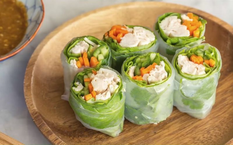 Gỏi cuốn is a traditional Vietnamese dish with boiled shrimp, pork, vermicelli, and raw vegetables rolled in rice paper