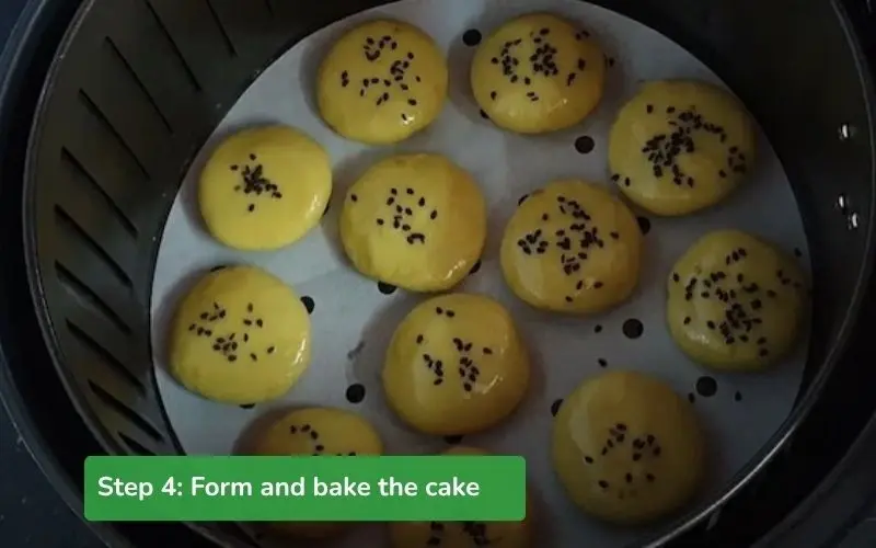 Shape the cookies, stuff them with cheese, and sprinkle them with black sesame before baking