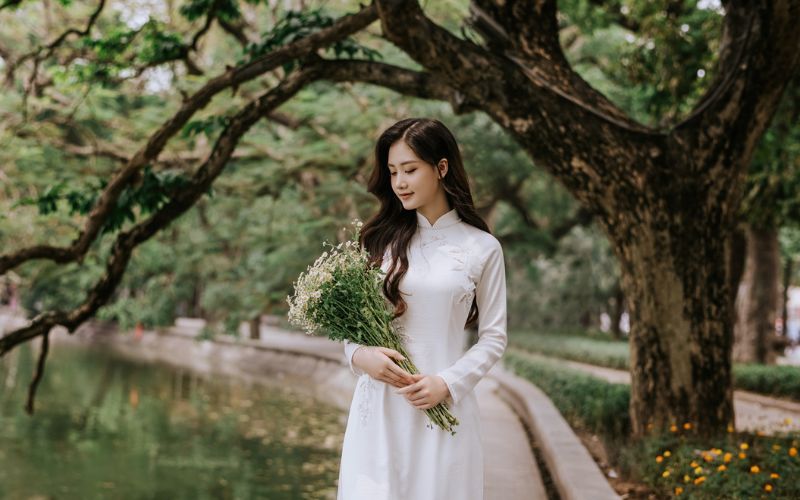 Pose naturally while walking along the lake shore.